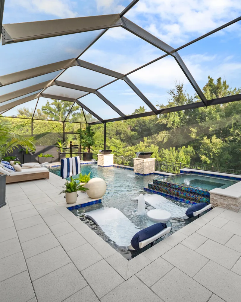 Custom pool with stone pillars, water bowls and deck jets built by Pool Perfection in Tampa