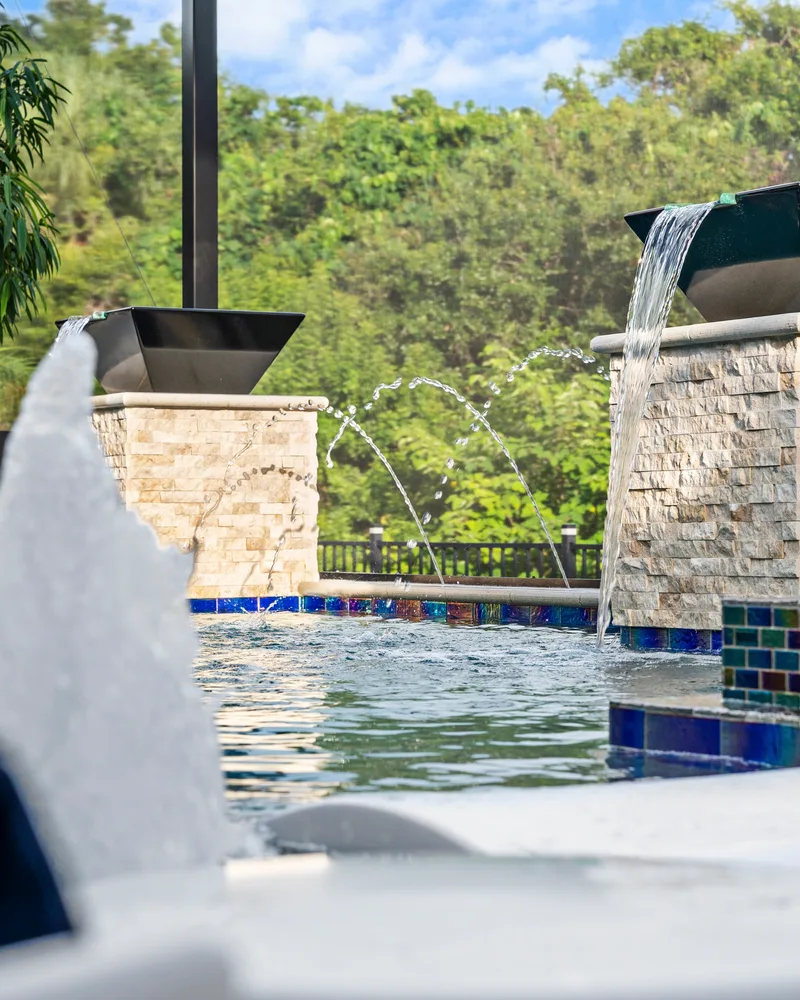 Custom pool with stone pillars, water bowls and deck jets built by Pool Perfection in Tampa